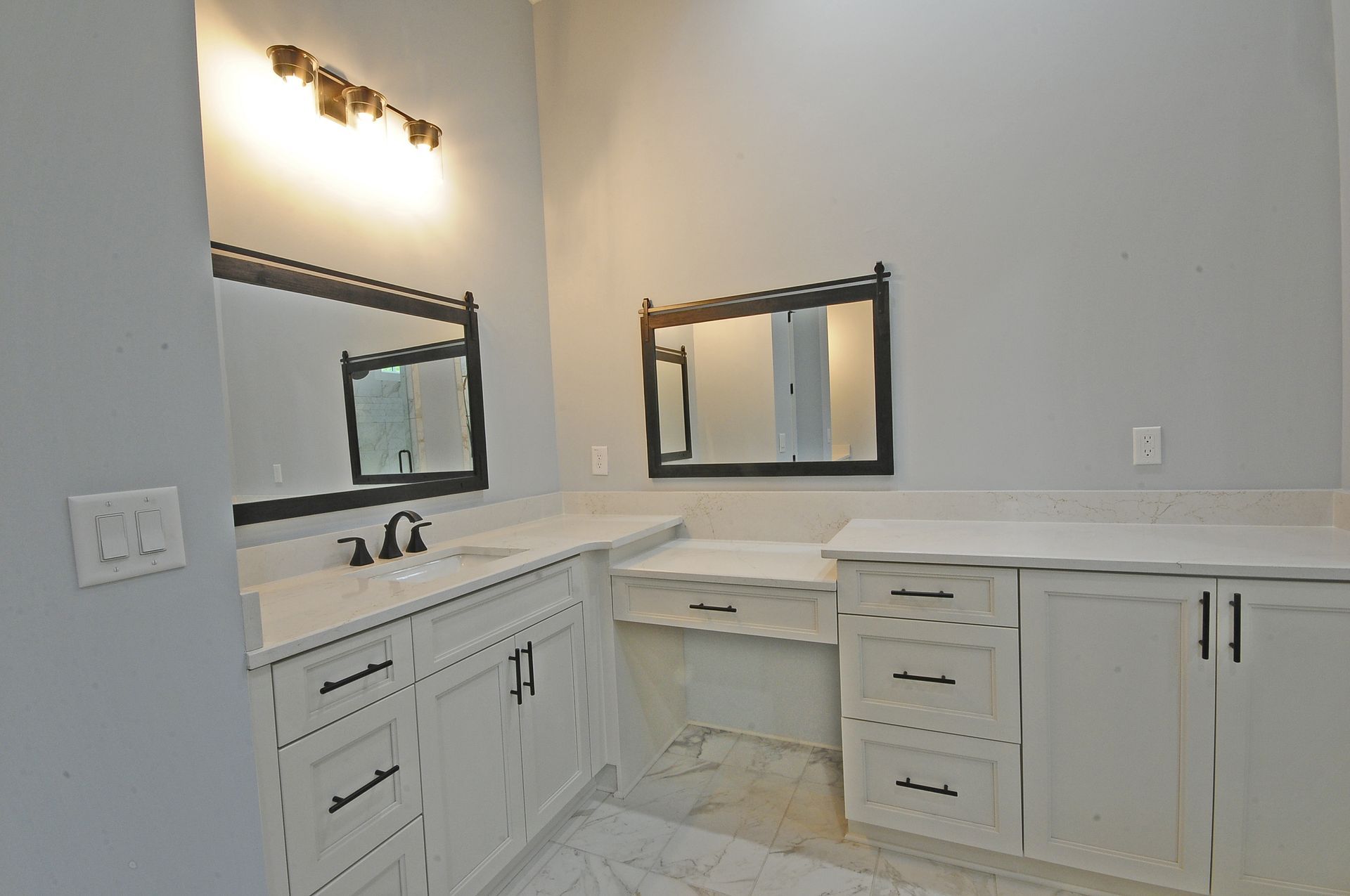 A bathroom with two sinks and two mirrors.