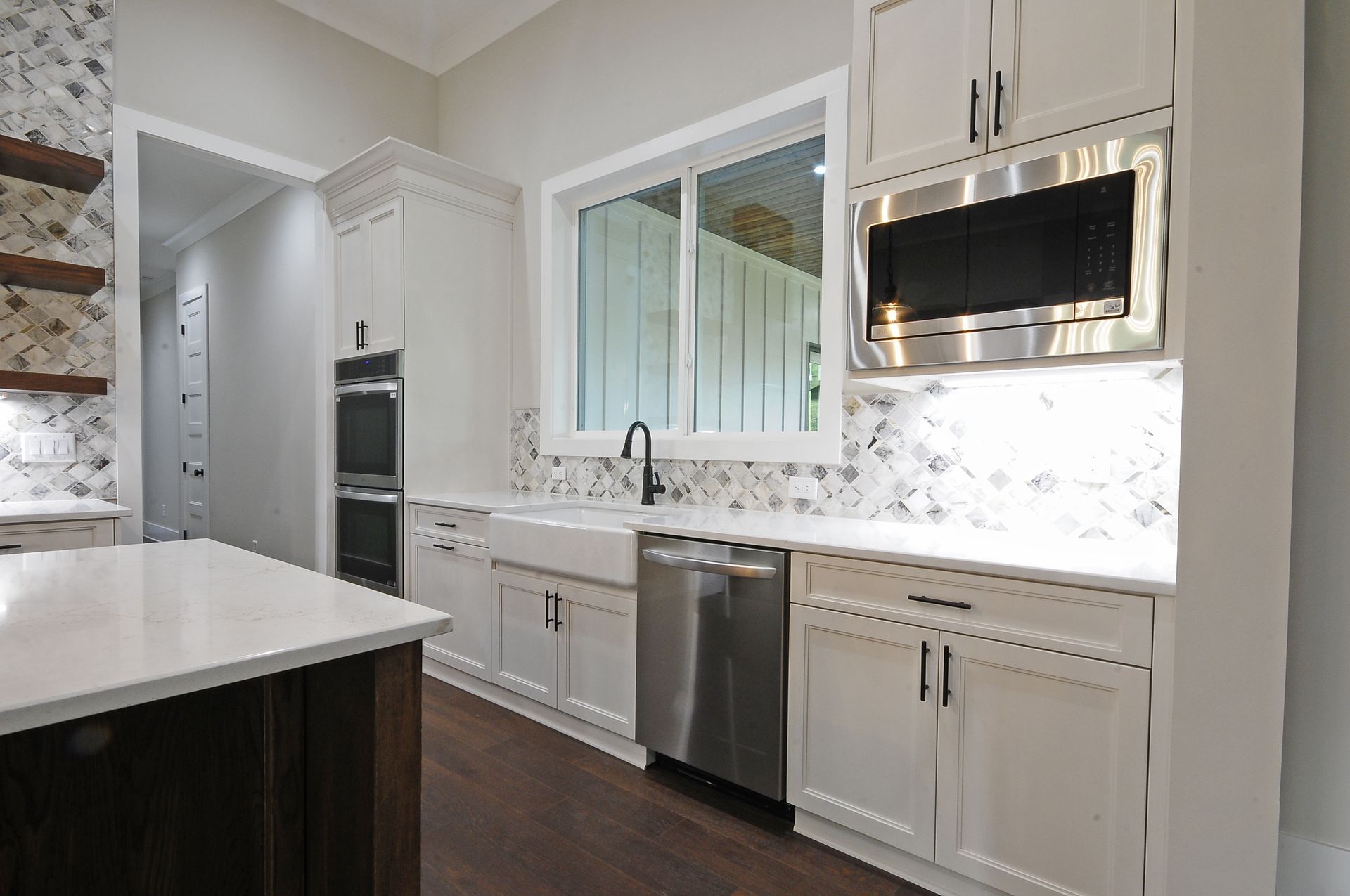 A kitchen with white cabinets and stainless steel appliances