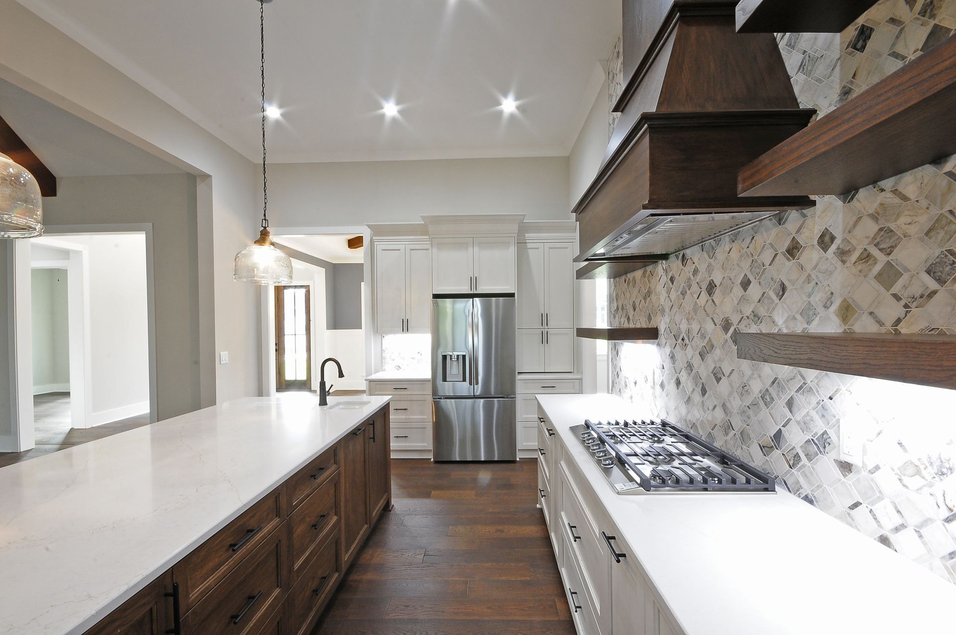 A kitchen with a stove top oven and a refrigerator