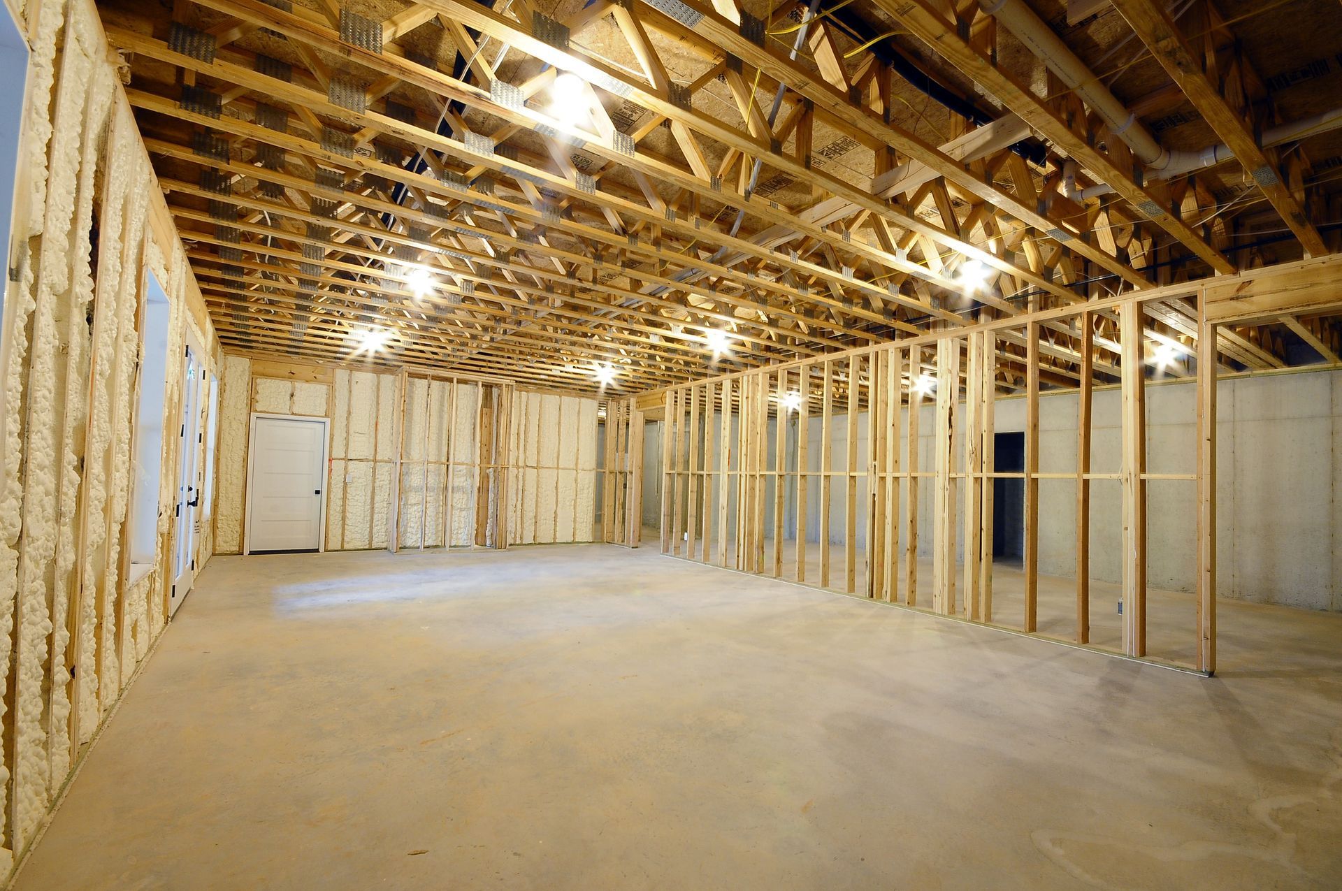 A large empty room with wooden beams and a ceiling.