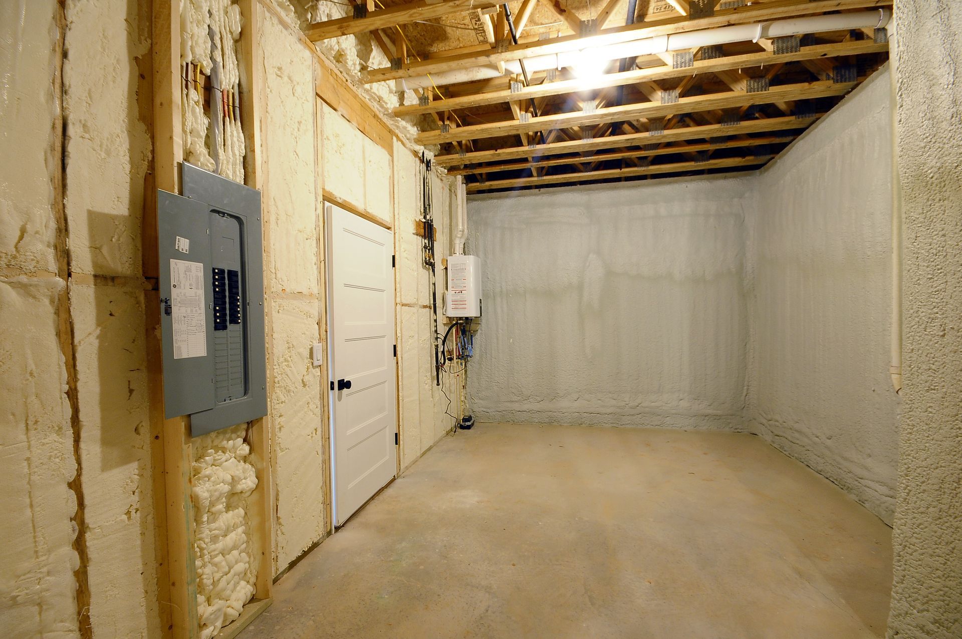 An empty room with a electrical box on the wall