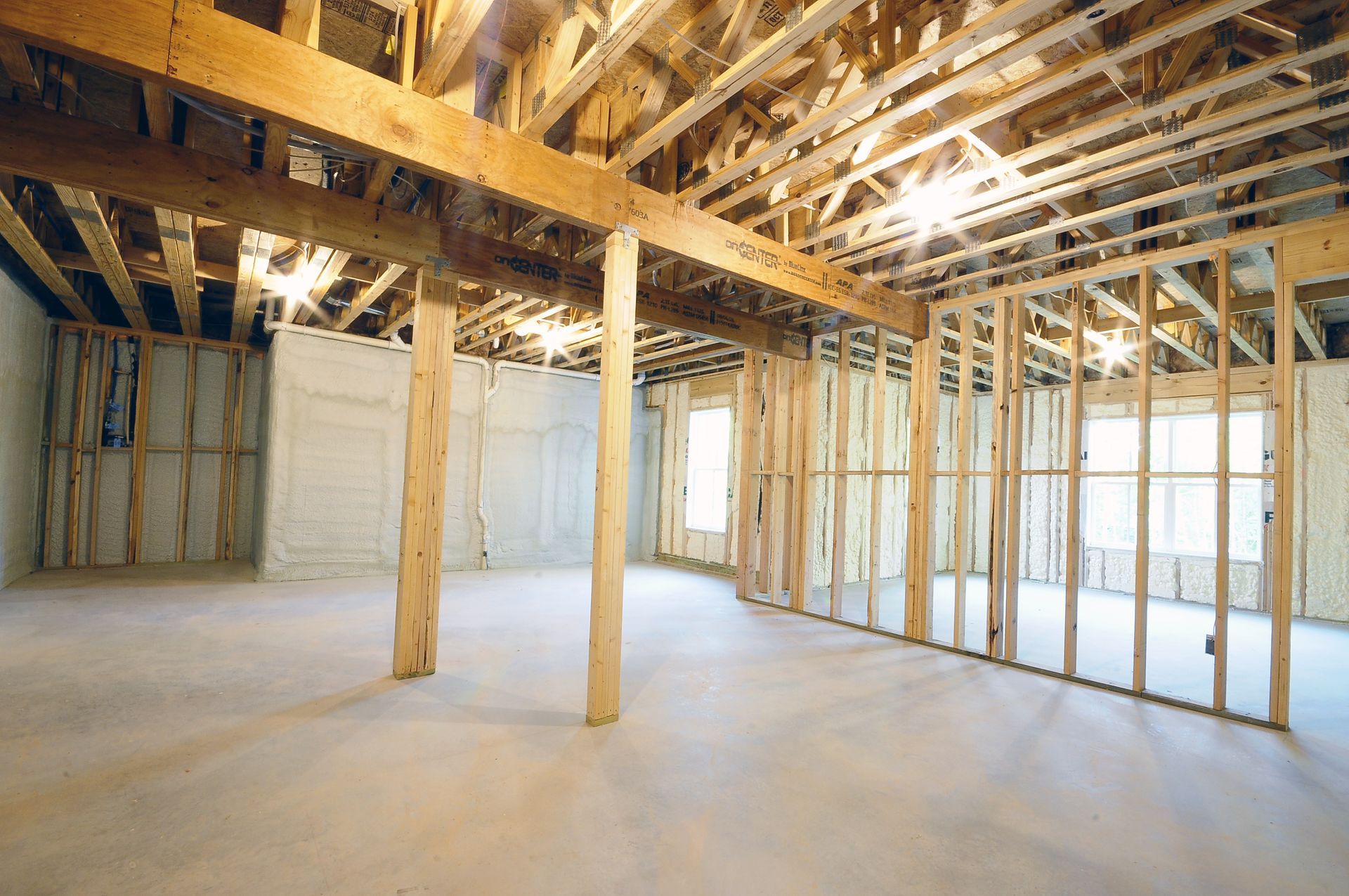 A large empty room with wooden beams and a ceiling.