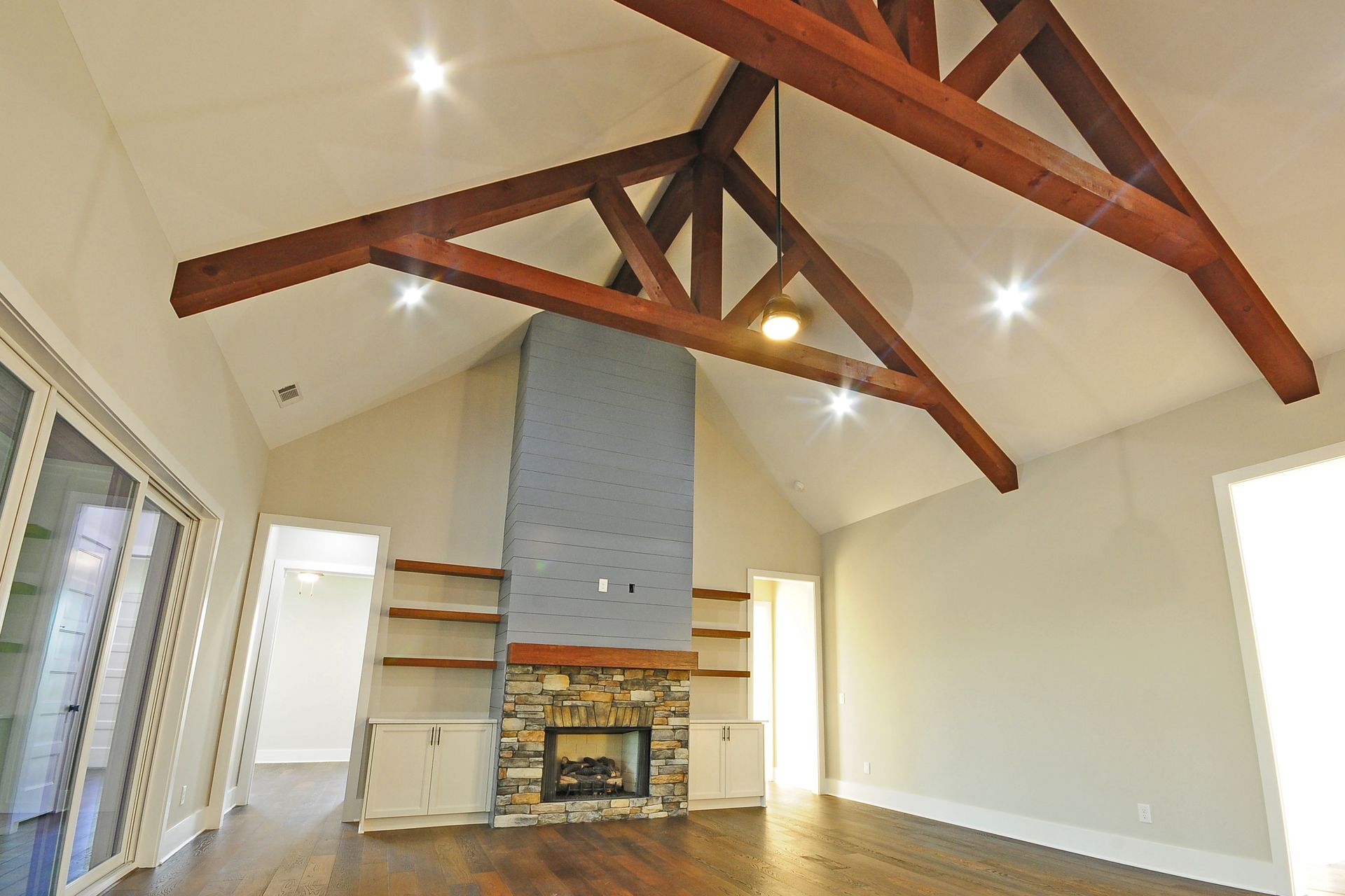 A living room with a fireplace and wooden beams