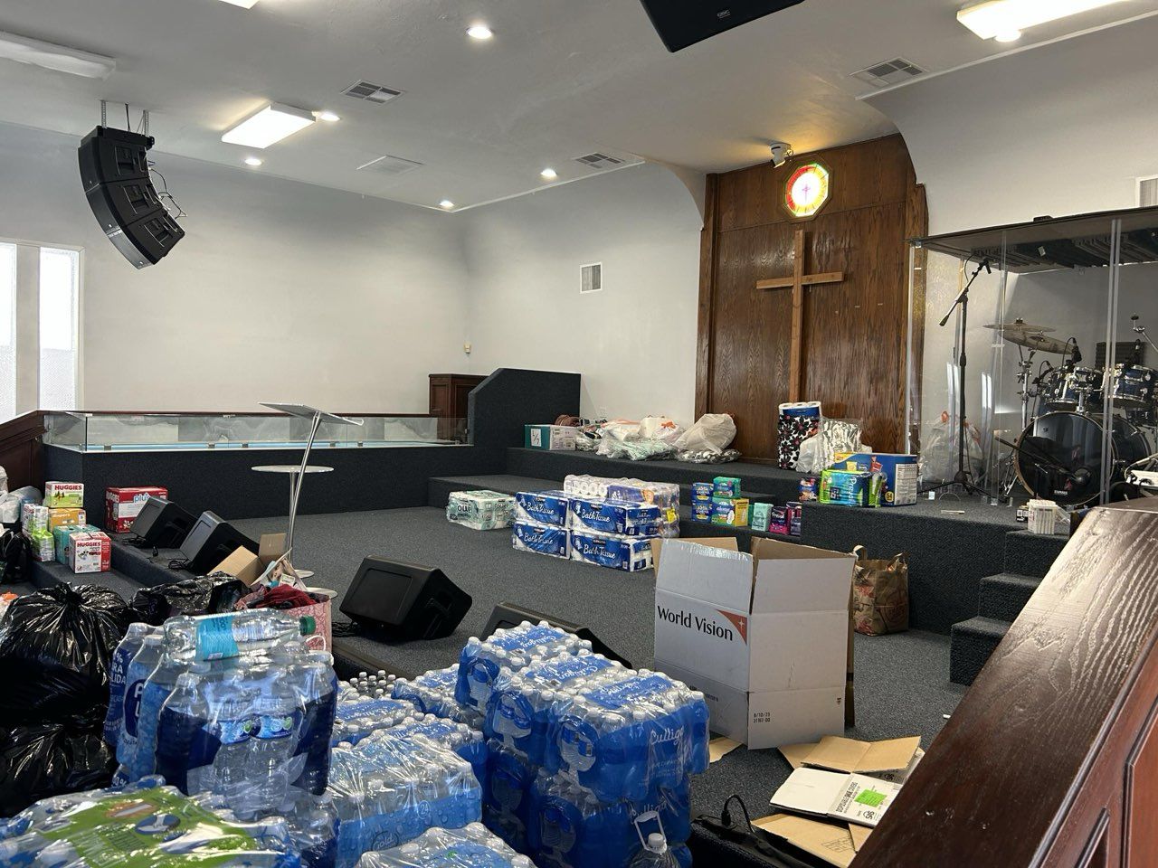 A church filled with lots of toilet paper and water bottles.