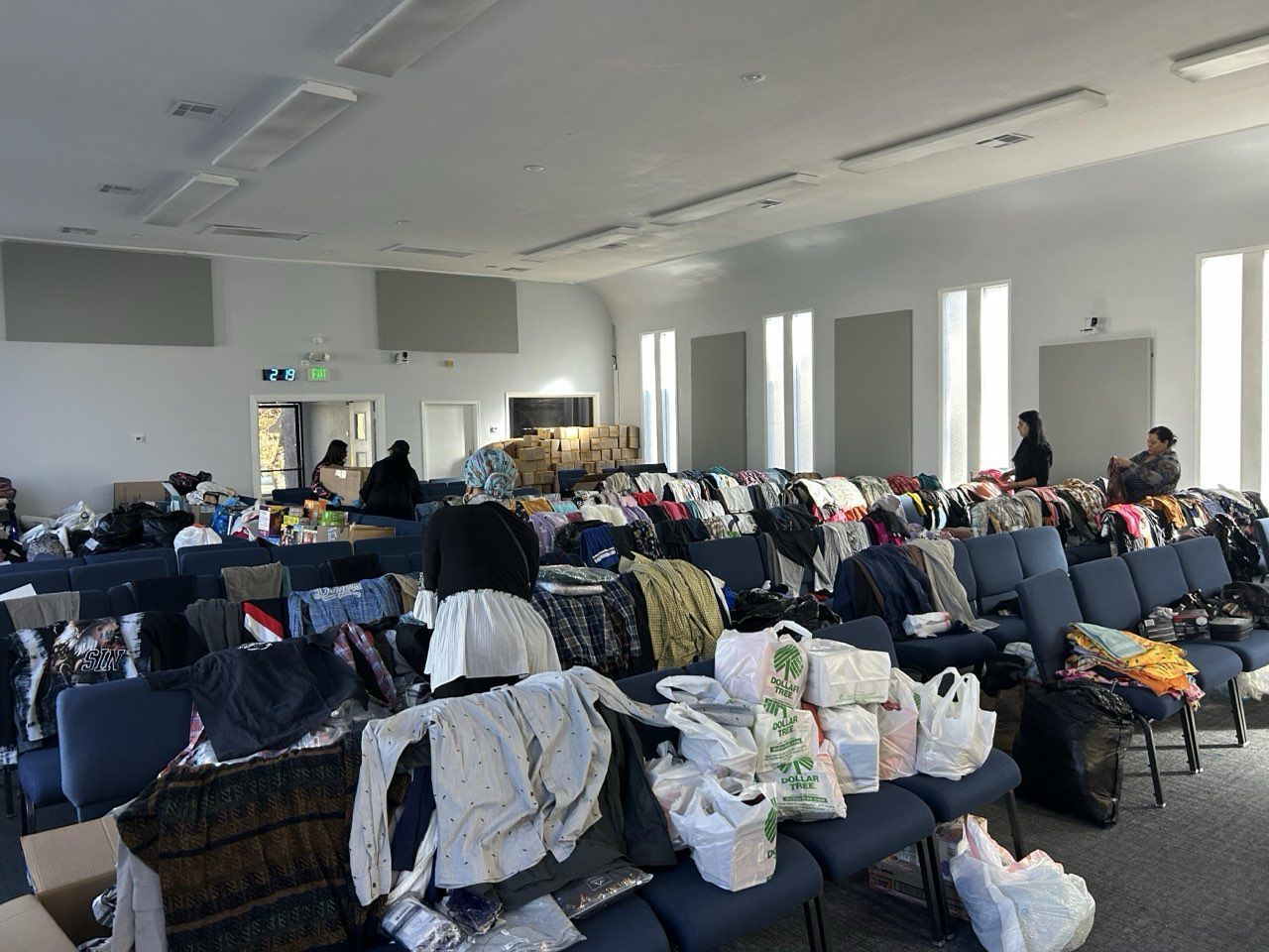 A large room filled with lots of clothes and bags.