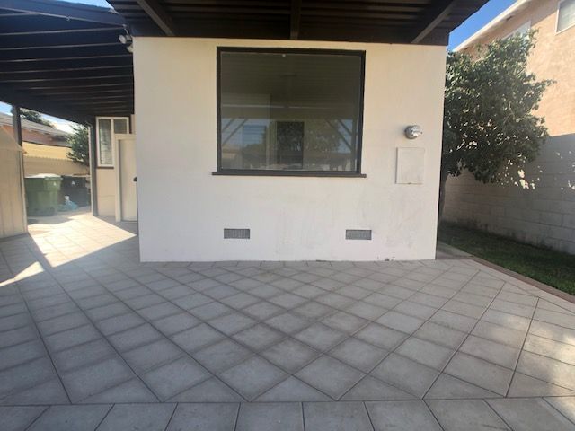 A white building with a window on the side of it