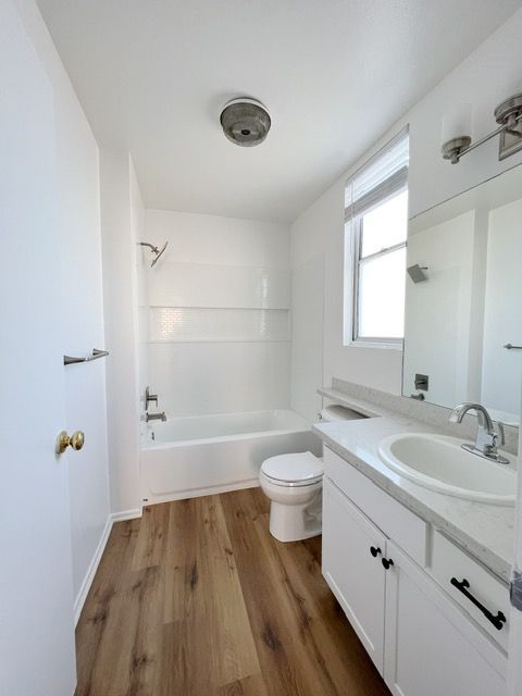 A bathroom with a sink toilet and bathtub