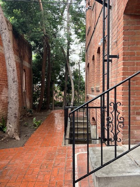 A brick building with stairs leading up to it