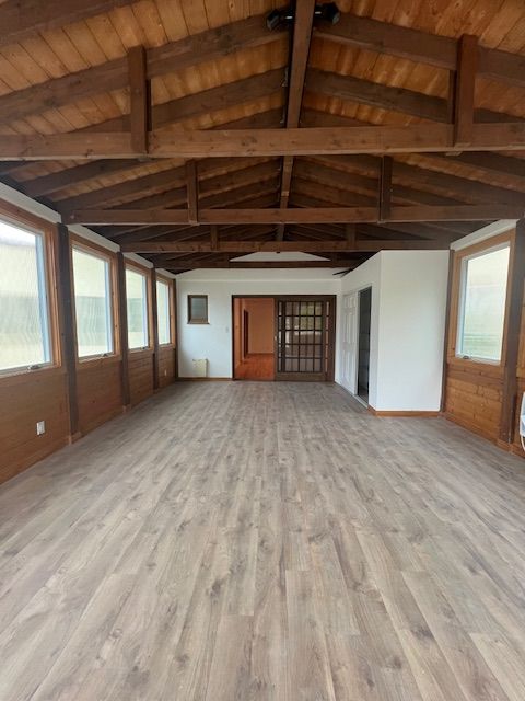 An empty room with wooden floors and a wooden ceiling