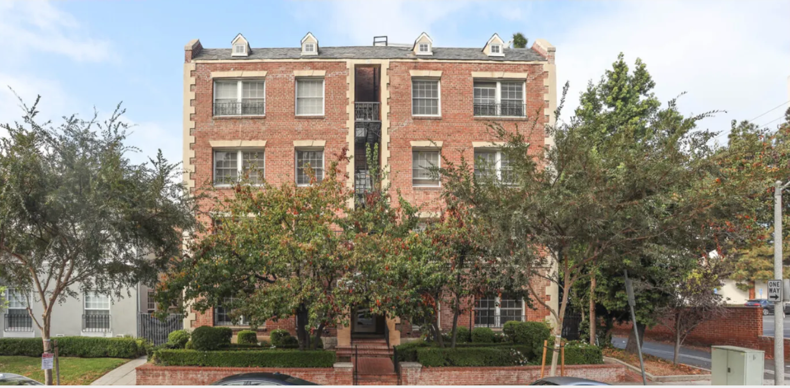 A large brick building with trees in front of it