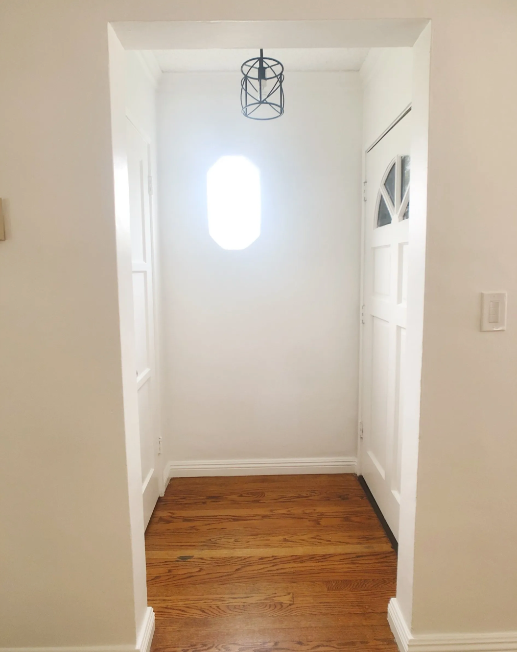 A hallway with a light hanging from the ceiling