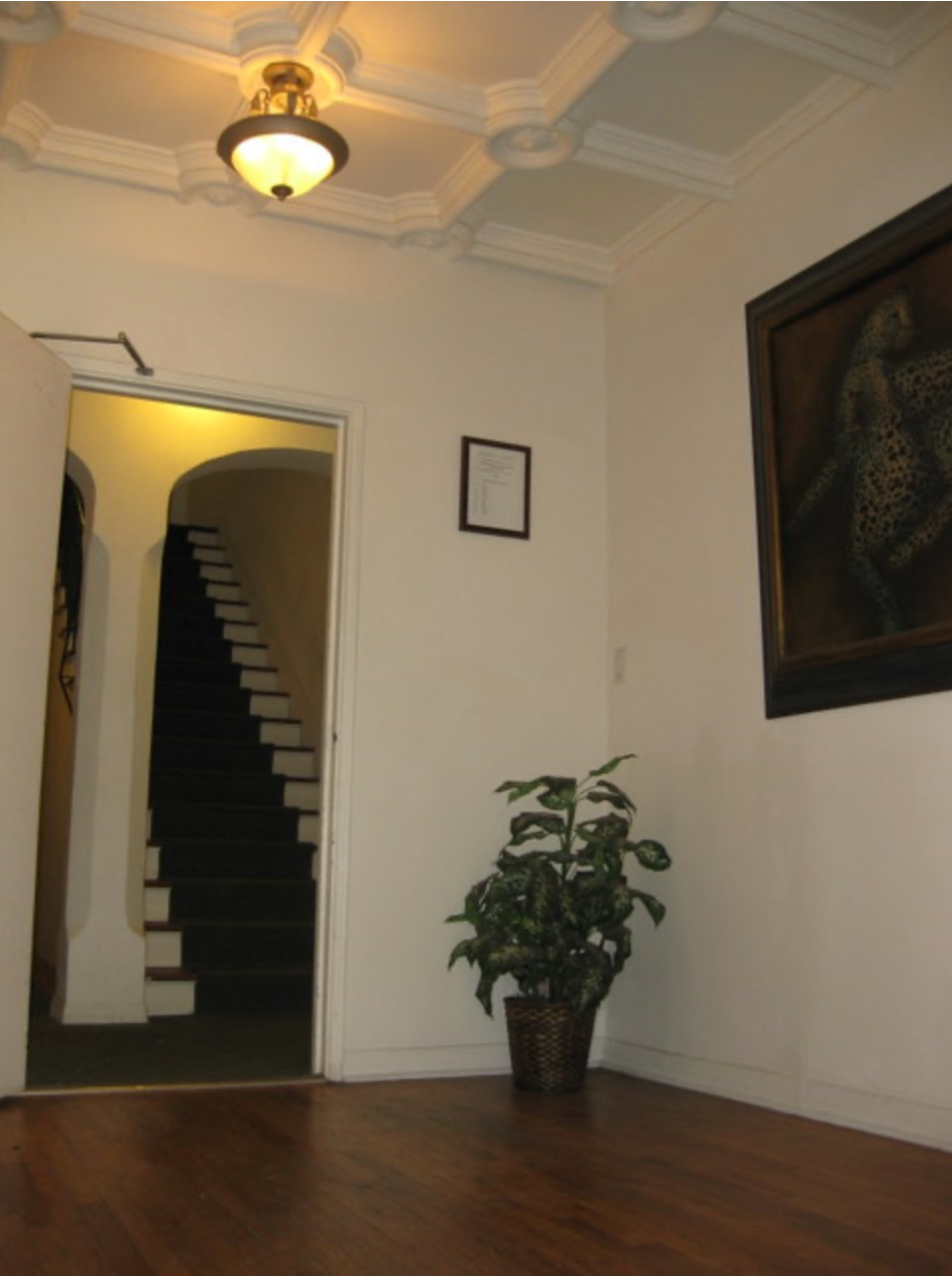 A room with stairs and a picture on the wall