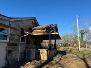 A house with a porch and a gutter on the side of it.