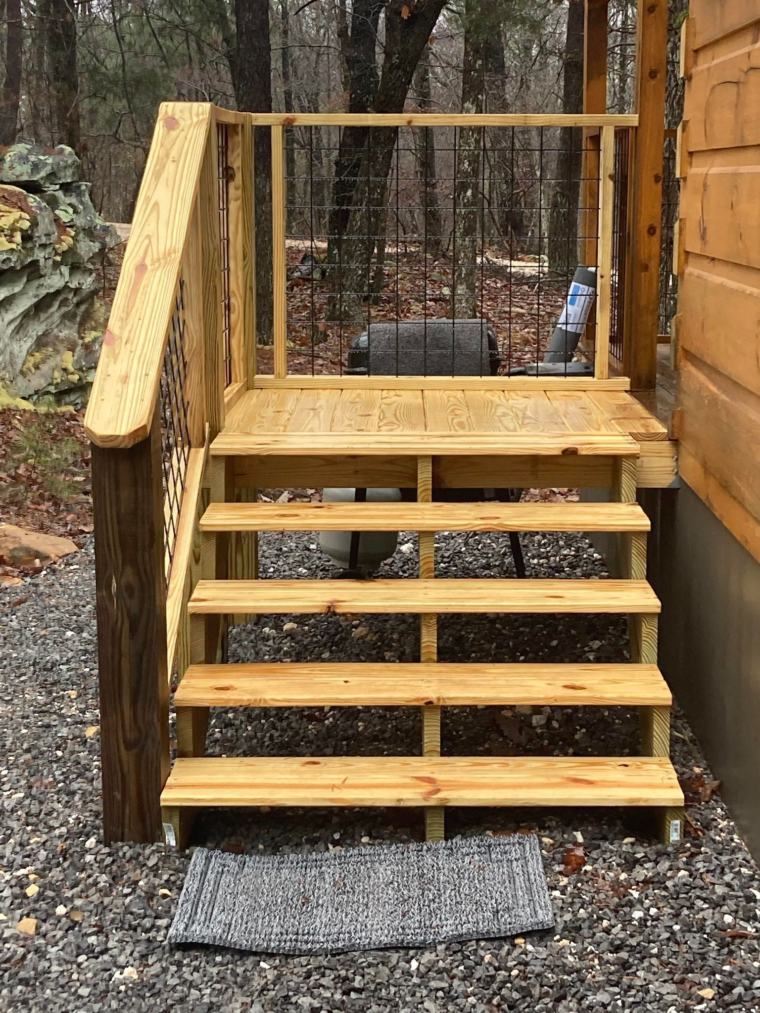 A wooden deck with stairs leading up to it.