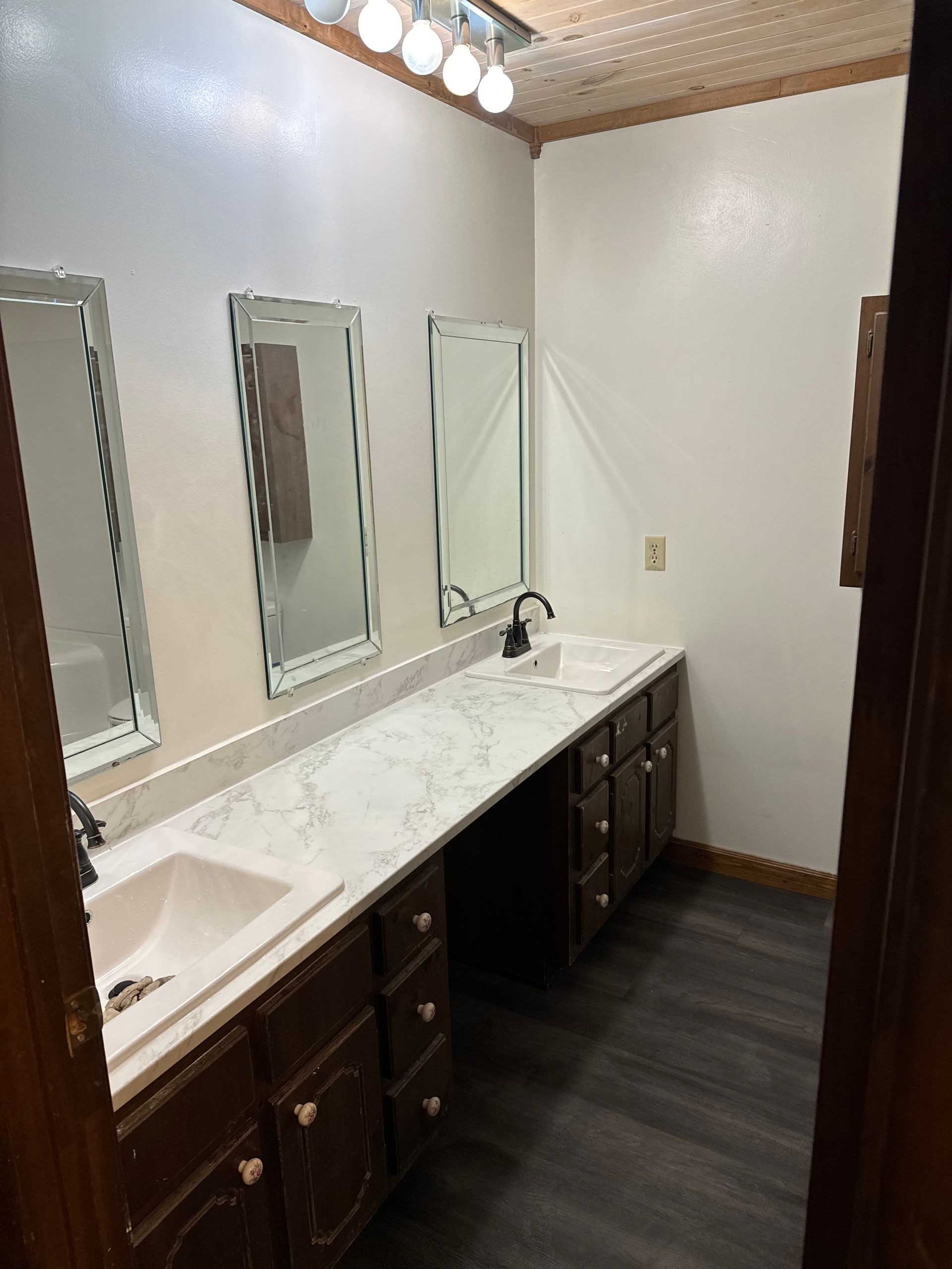 A bathroom with two sinks and two mirrors.