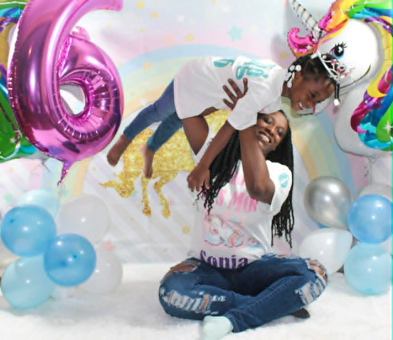 Person lifts another in a balloon-filled 16th birthday party scene with a large pink “16” balloon.