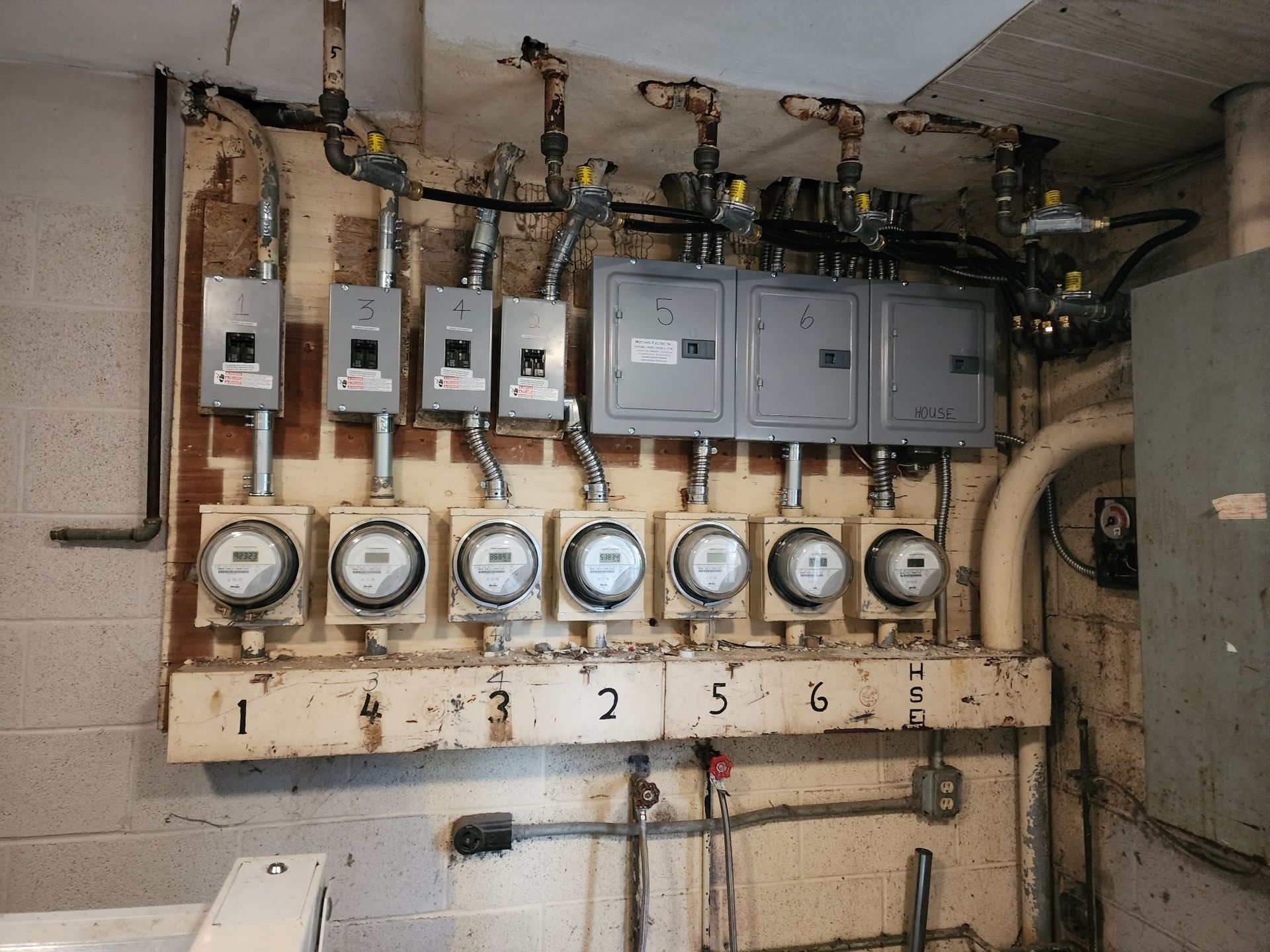 A man is standing on a ladder in a room under construction