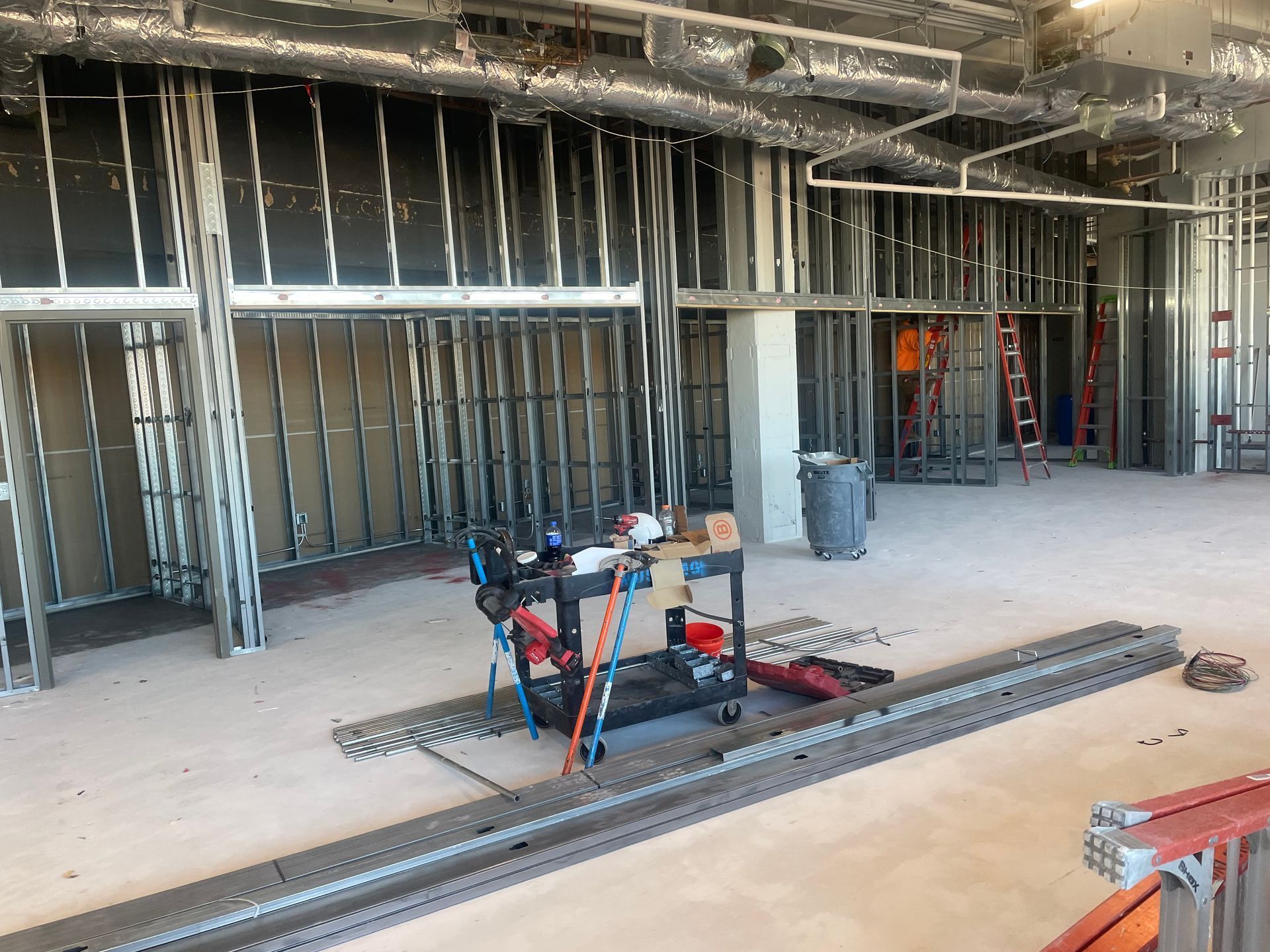 An empty room with a red exit sign on the wall