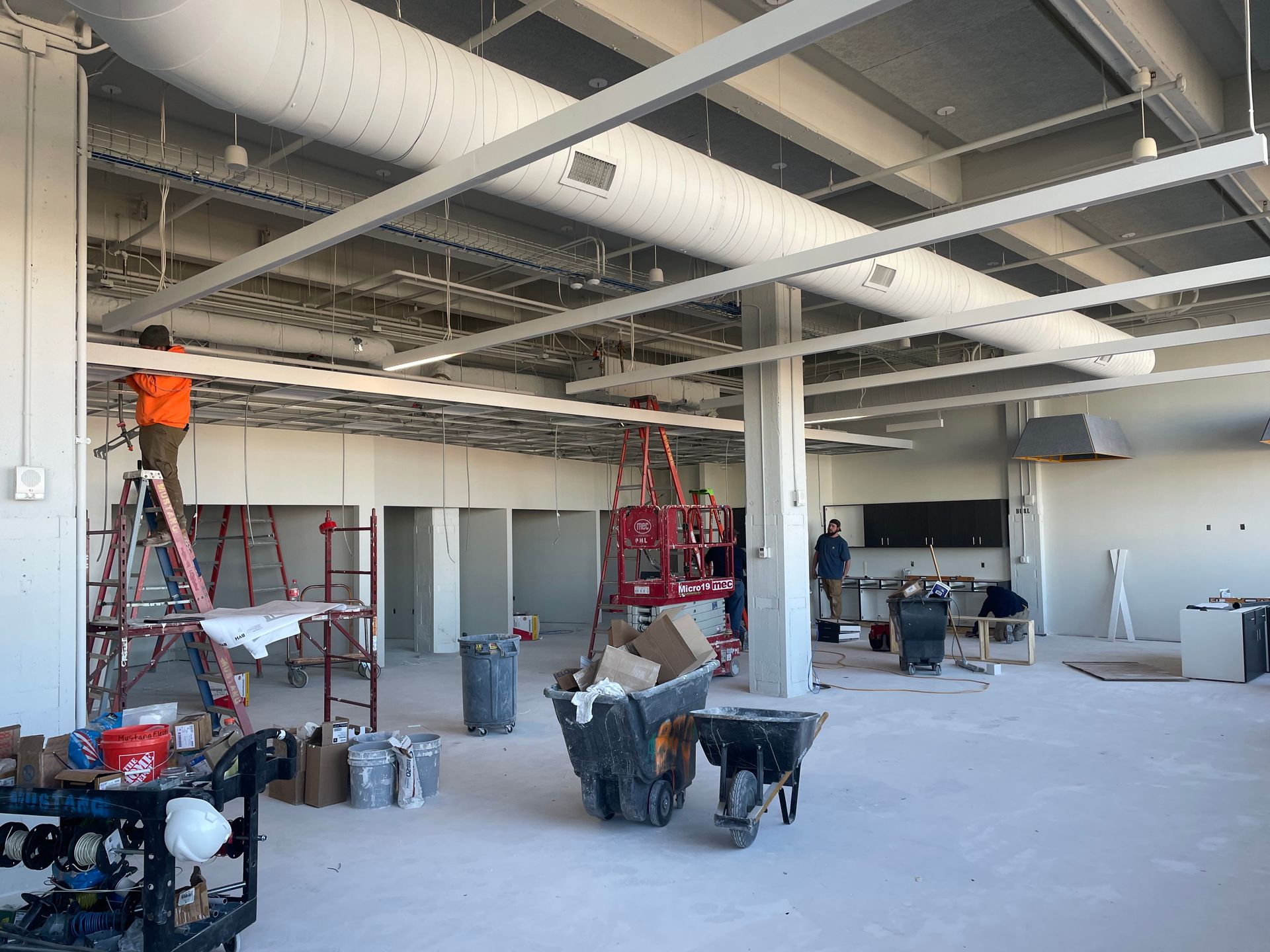 A large room with a lot of pipes hanging from the ceiling.
