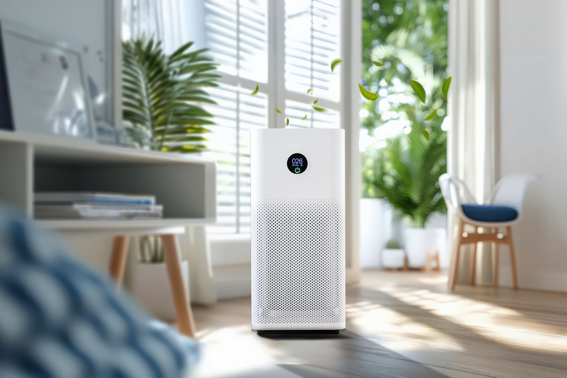 White air purifier in a sunny living room with plants, a window, and furniture.