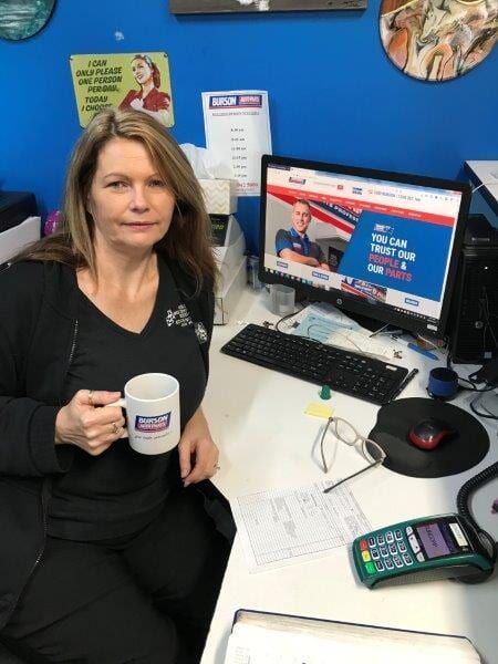 Woman at Desk, Holding Mug, Looking at Computer With Automotive Website — Mike's Automotive in Edgeworth, NSW