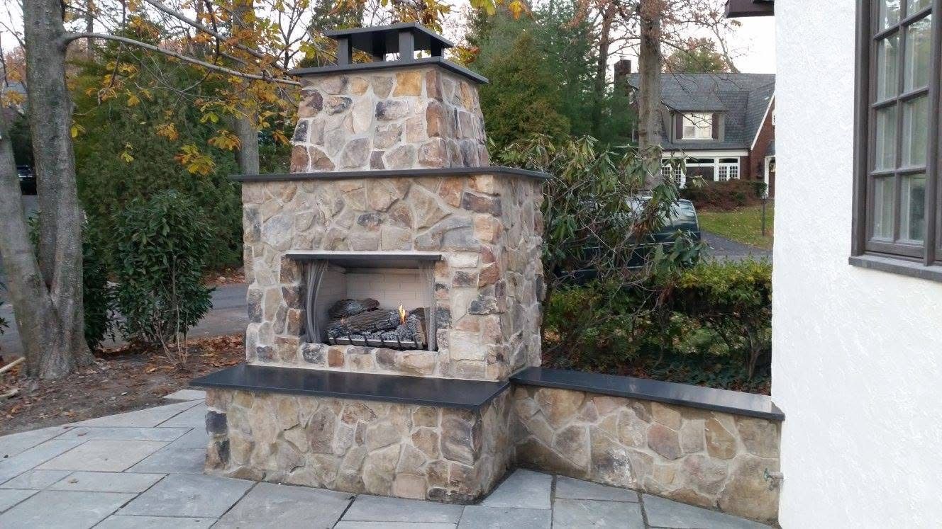 Elegant bathroom with marble walls, white vanity, and crystal chandelier.