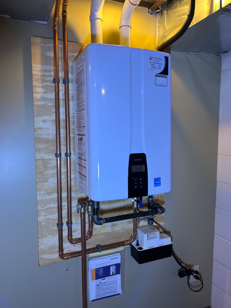 A white water heater in a basement