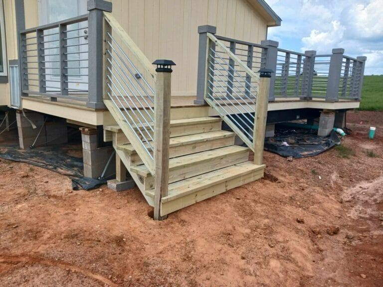 A wooden deck with stairs leading up to it