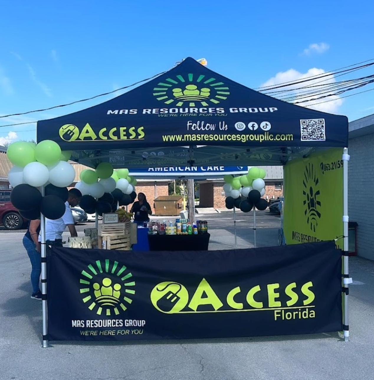 A tent with balloons and a sign that says access florida