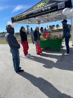 A group of people standing under a tent that says access