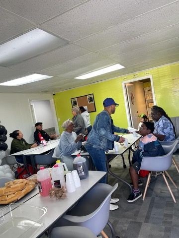 A group of people are sitting at tables in a room.