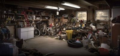 A garage filled with lots of junk and bicycles.