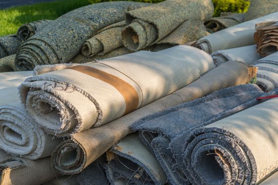 A pile of carpet rolls stacked on top of each other.