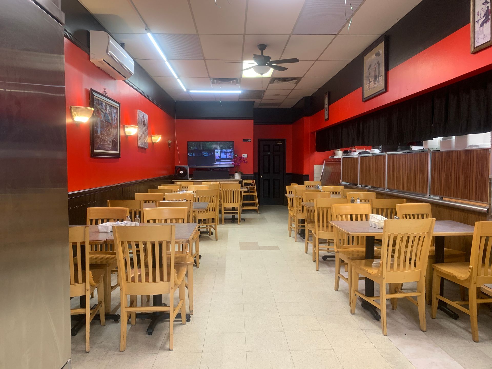 The inside of a restaurant with tables and chairs