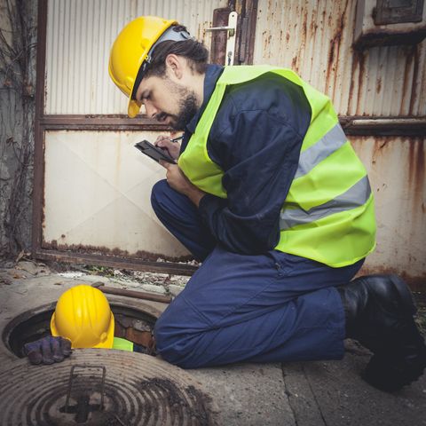 commercial sanitation — two worker checking sewer in Cleveland, OH