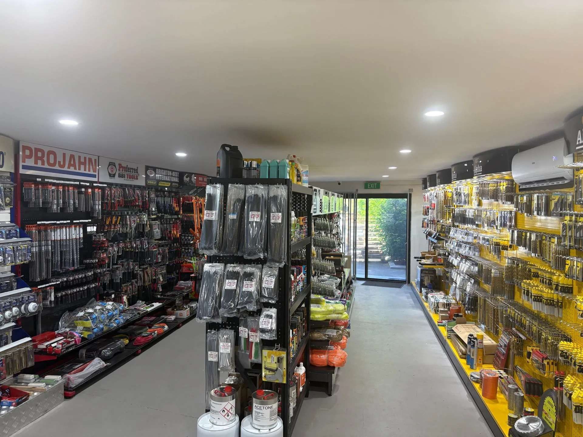 Hardware store interior with tools displayed on shelves.