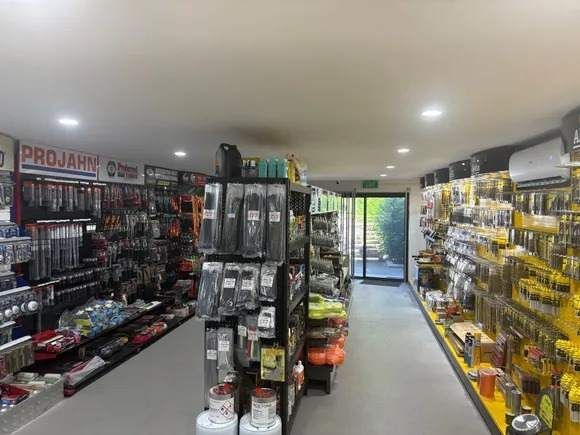 Hardware store interior with tools displayed on shelves.