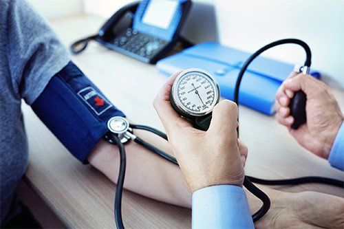 Doctor Measuring Patient's Blood Pressure