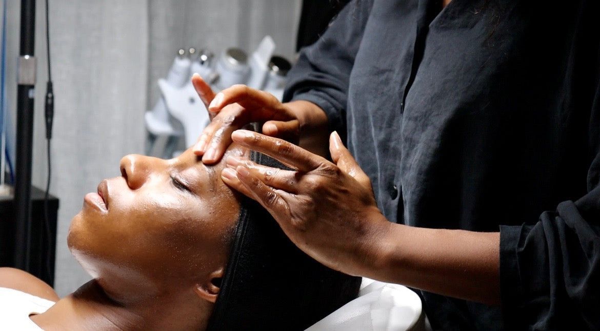 A woman is getting a massage on her face at a spa.