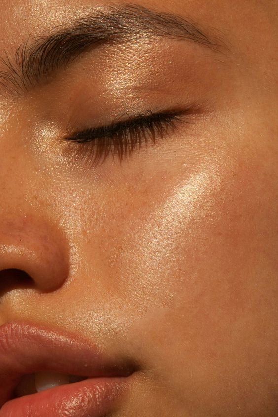 A close up of a woman 's face with her eyes closed.