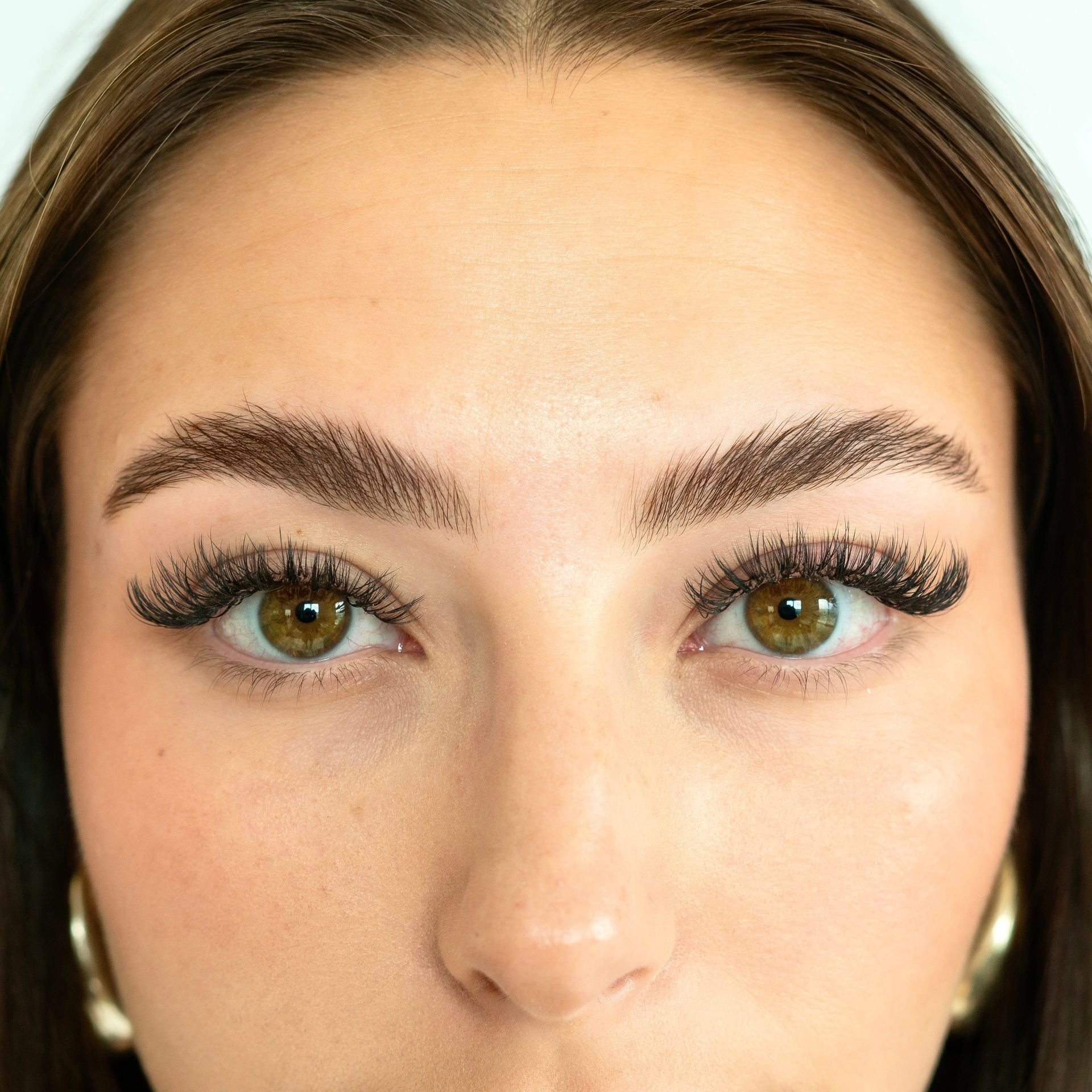 A woman is getting her eyelashes done at a beauty salon.