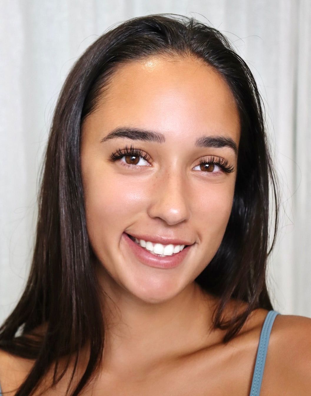 A close up of a woman 's face with her eyes closed.