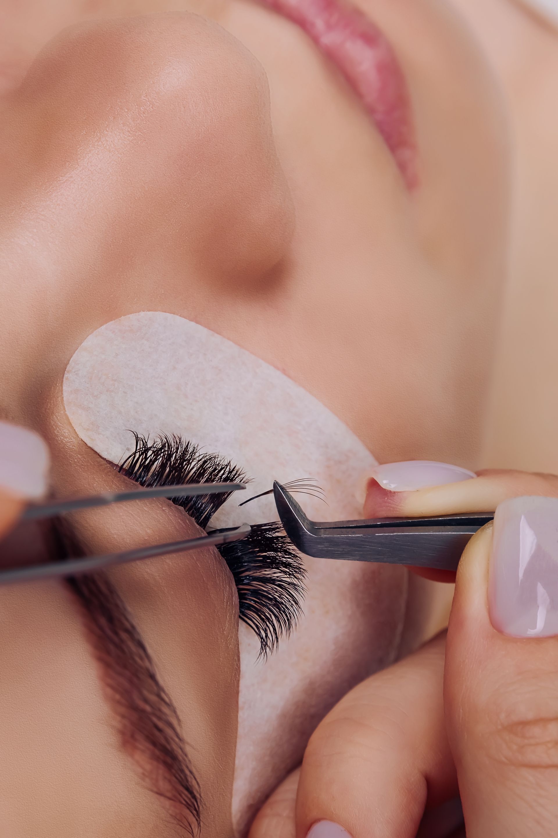 A close up of a woman 's eye with long eyelashes.