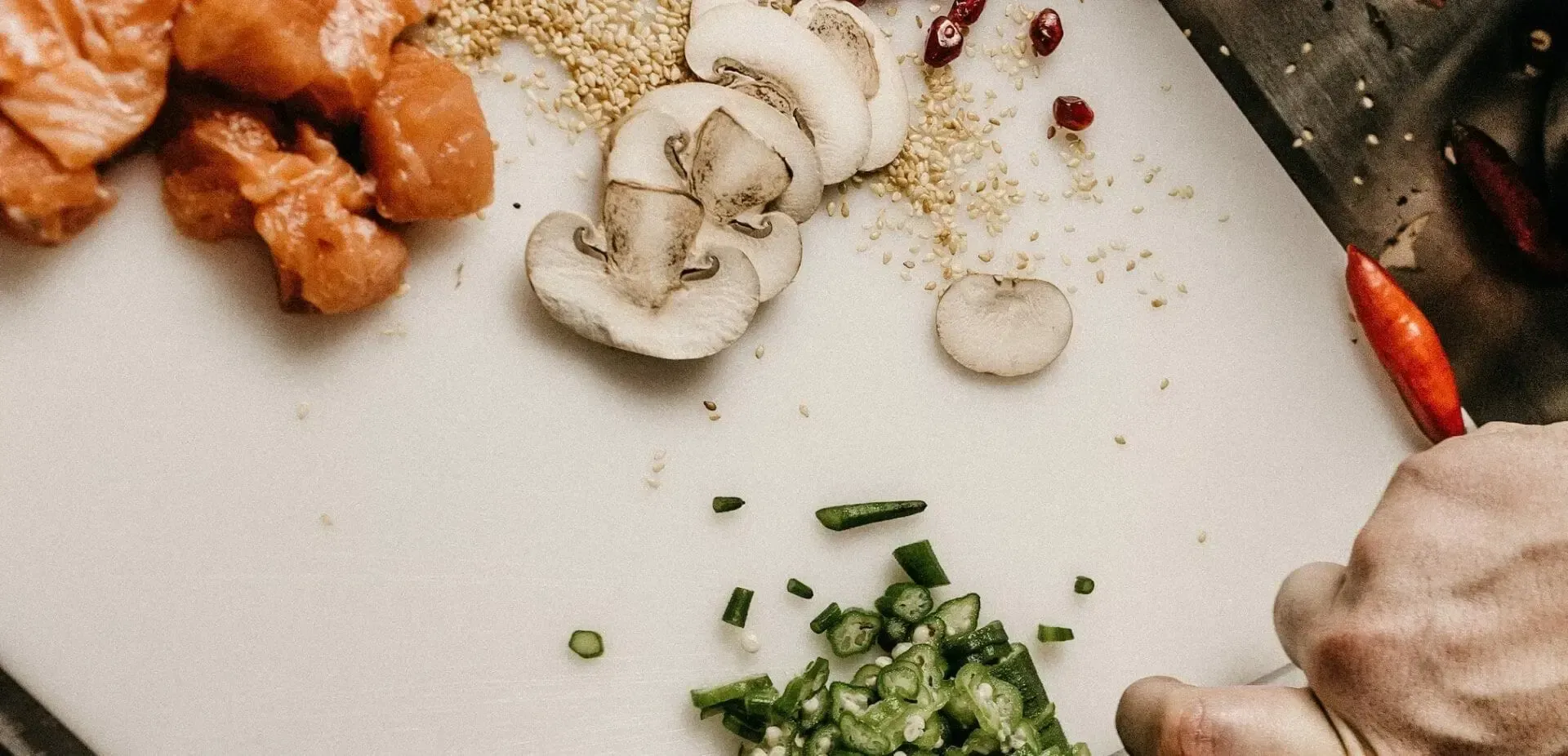 A person is cutting vegetables on a cutting board.