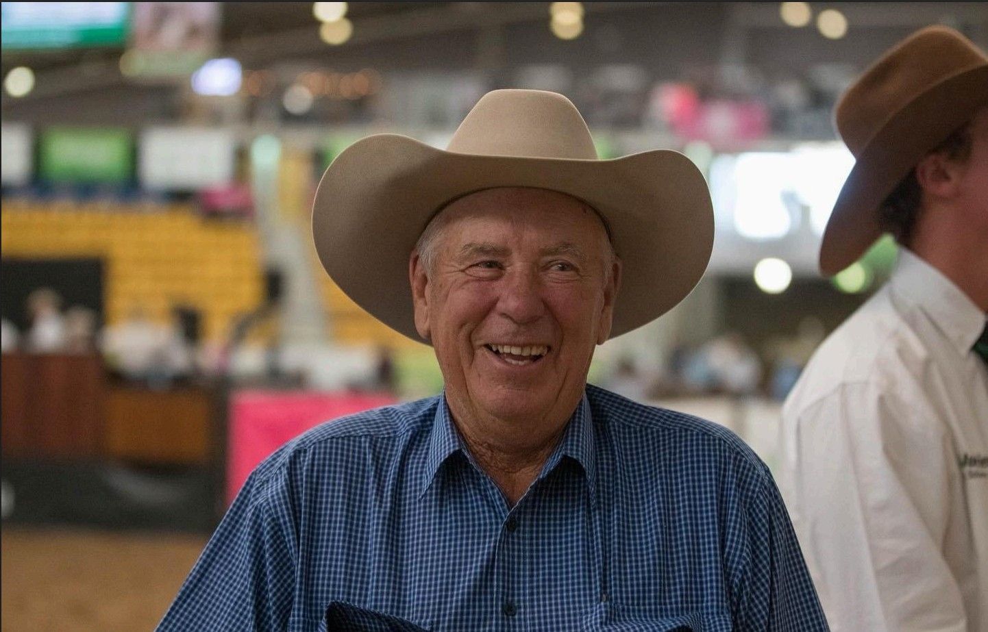 A man is riding a bull on a horse in a rodeo.