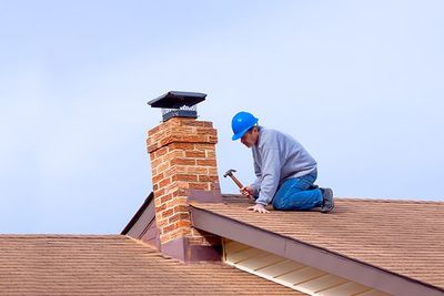 Worker Repairing Chimney on Rooftop — Springfield, VA — A-1 Chimney Sweep & Dryer Vent Service, LLC