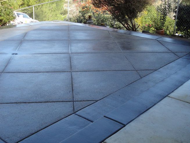 Gray concrete driveway with a dark border.