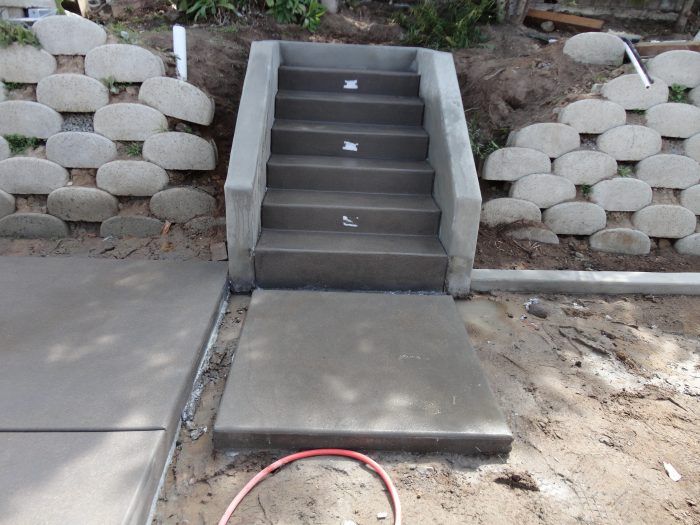 Concrete stairs leading up, with retaining walls on either side.