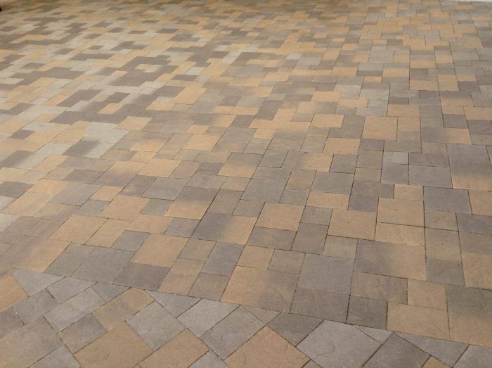 Patterned brick patio with alternating tan and gray squares.