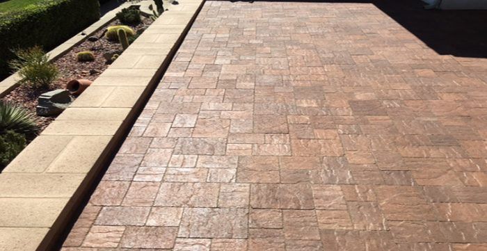 Stamped concrete patio with a textured brick pattern in shades of brown.
